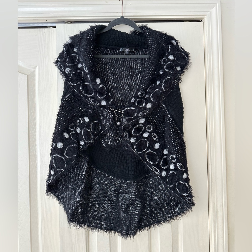Super soft, stylish, unique sweater vest.Great detail, design, silver pin clasp.